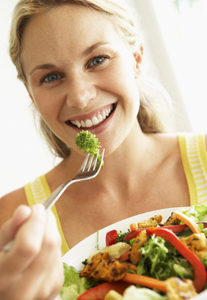 Mid Adult Woman Eating A Healthy Salad